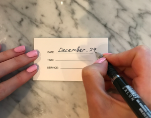 woman signing business card