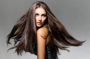 Woman with long brown hair blowing