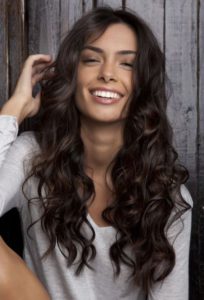 Woman with long brown wavy hair