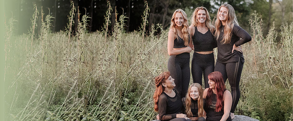 women-sitting-on-rock-in-field
