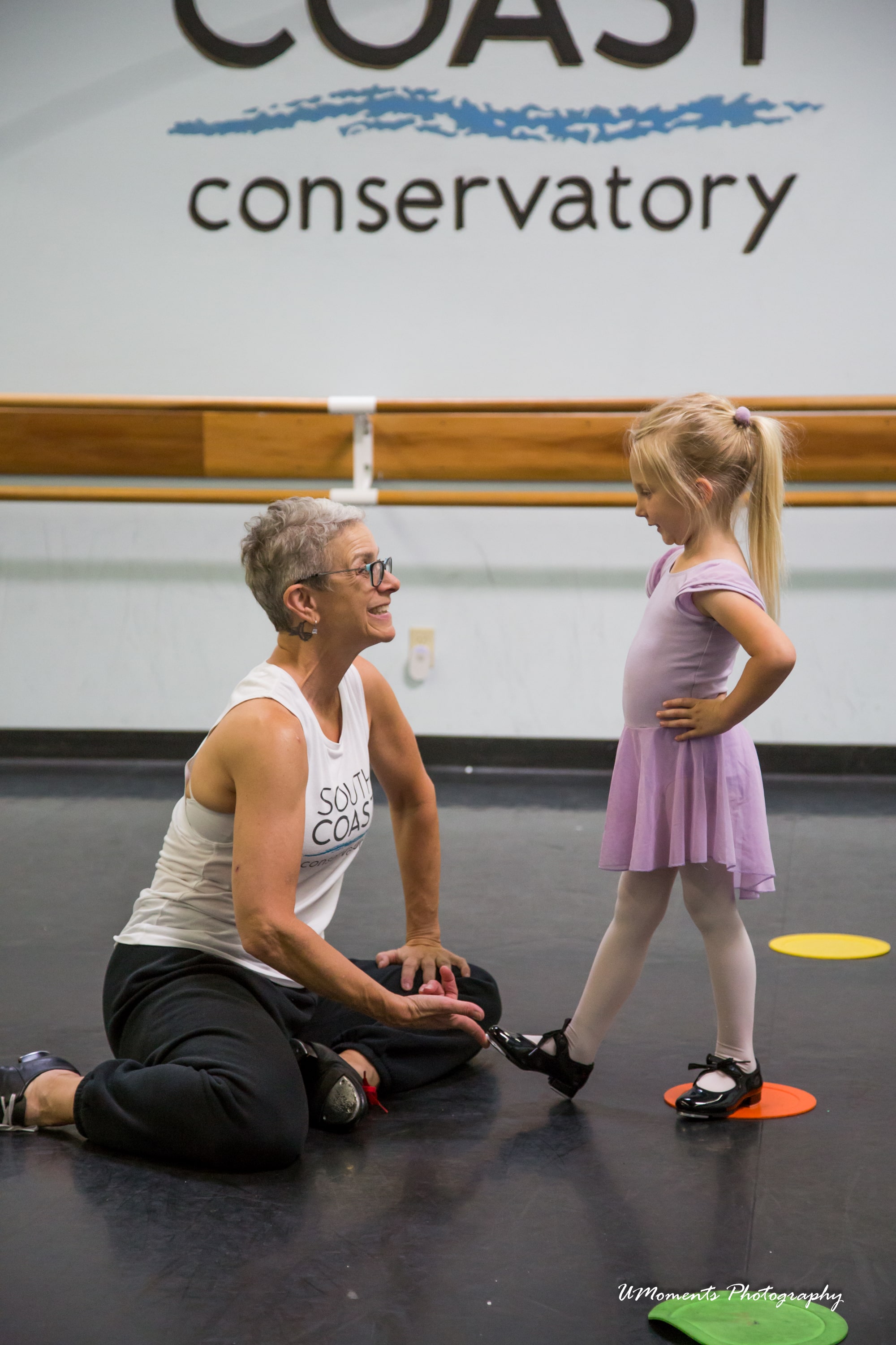 young dancer practicing tap with dance teacher