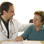 Doctor speaking to old woman