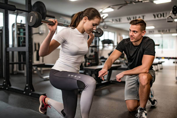 woman doing lunges during private training
