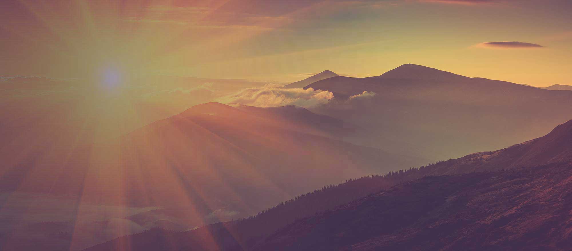 sun setting over a mountain