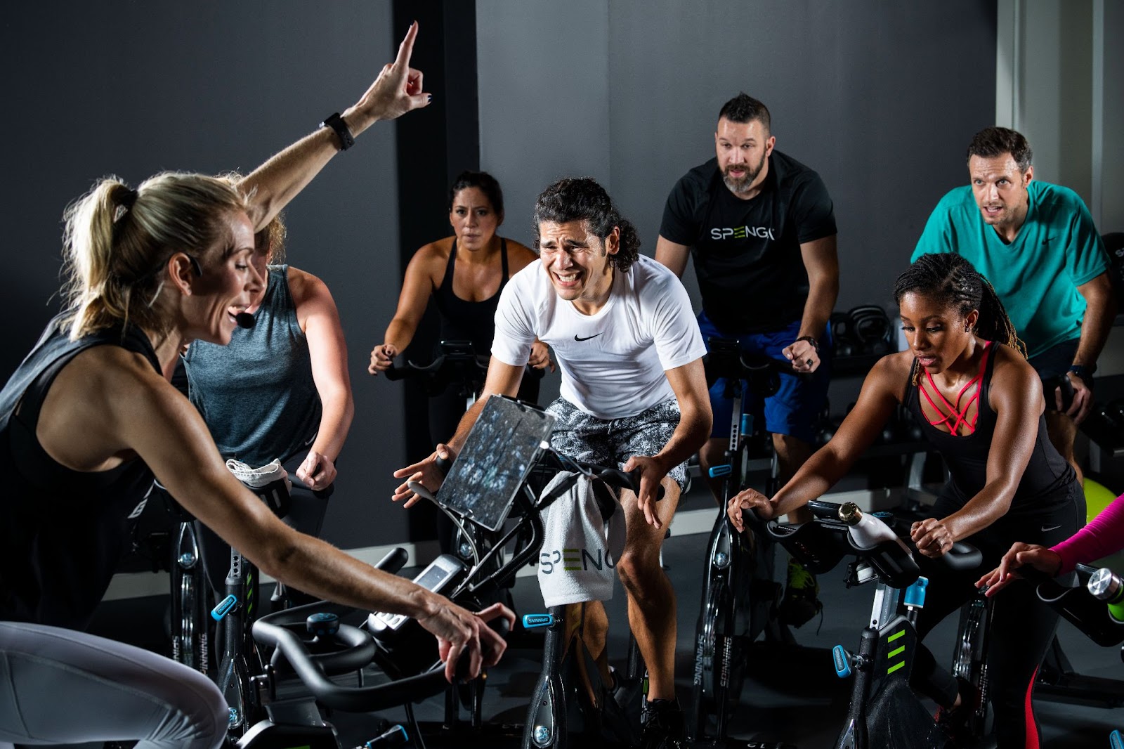 Group of SPENGA members on spin bikes in class