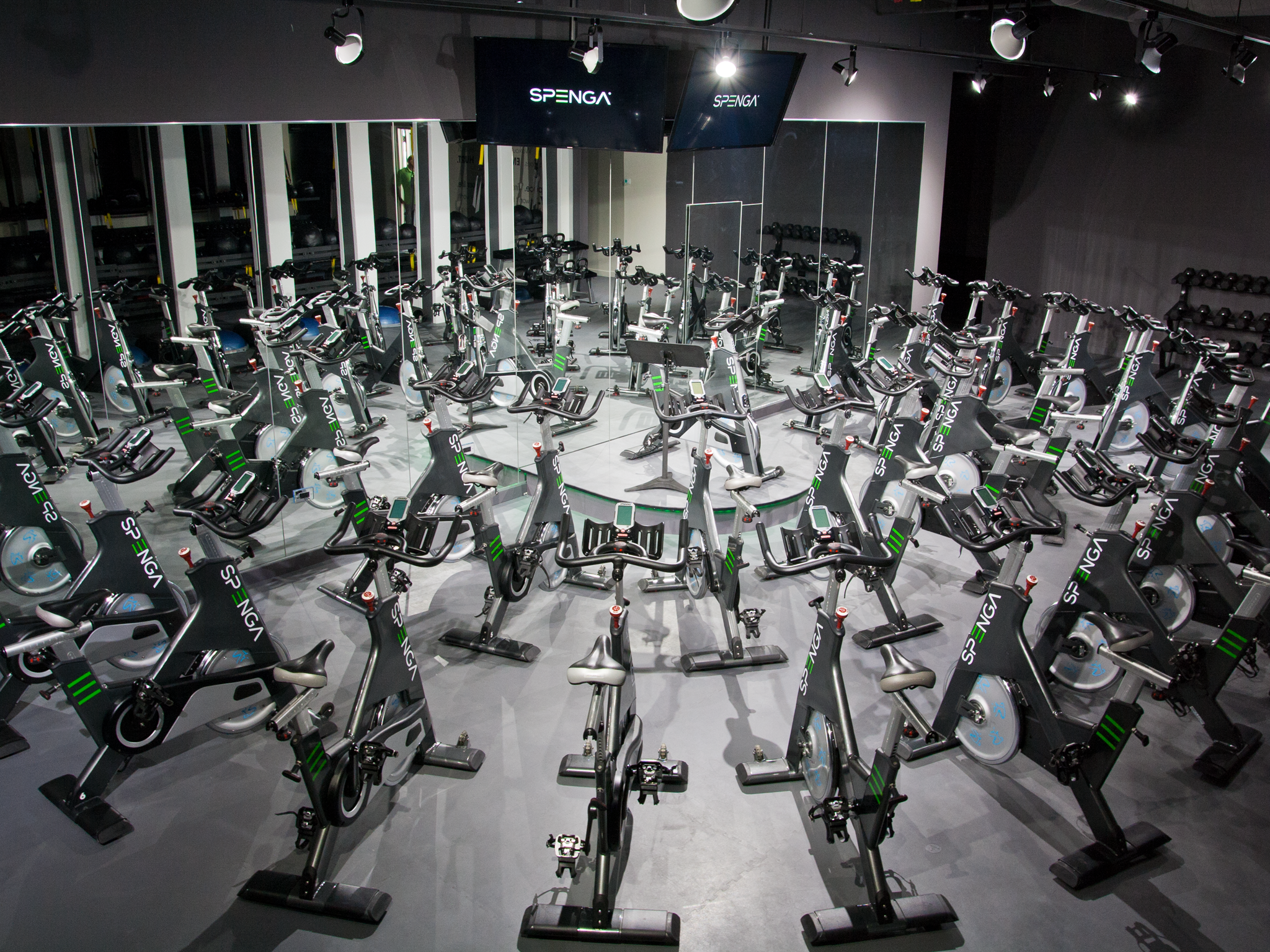 Spin bikes in a class with a tv above Spin bikes in a class with a tv above