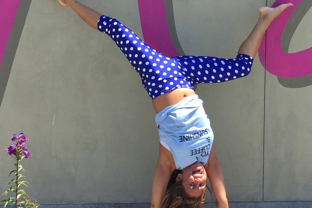woman doing head stand at SpinLuvPla
