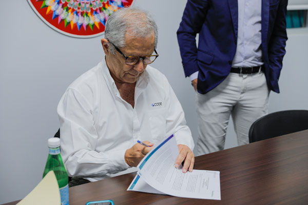 evolution-free-zone-team-signing-at-table