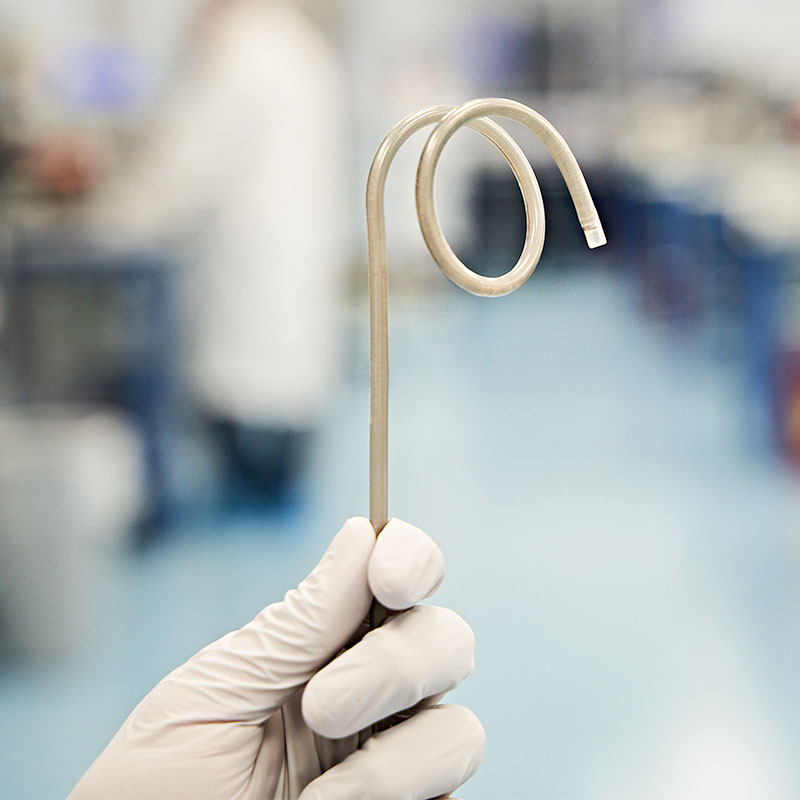 hand holding a spiral catheter