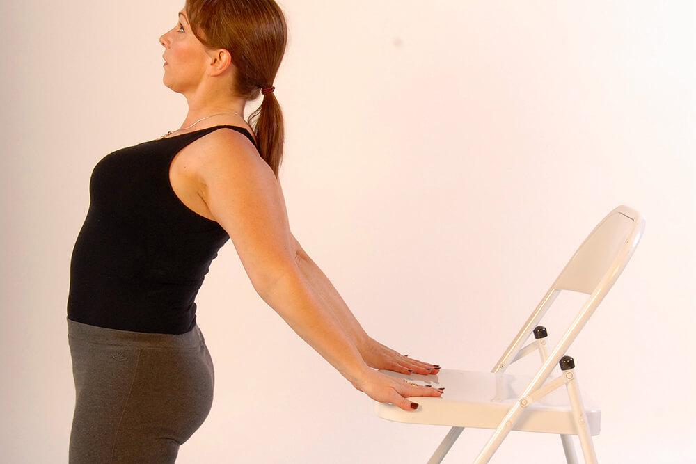 woman doing chair yoga