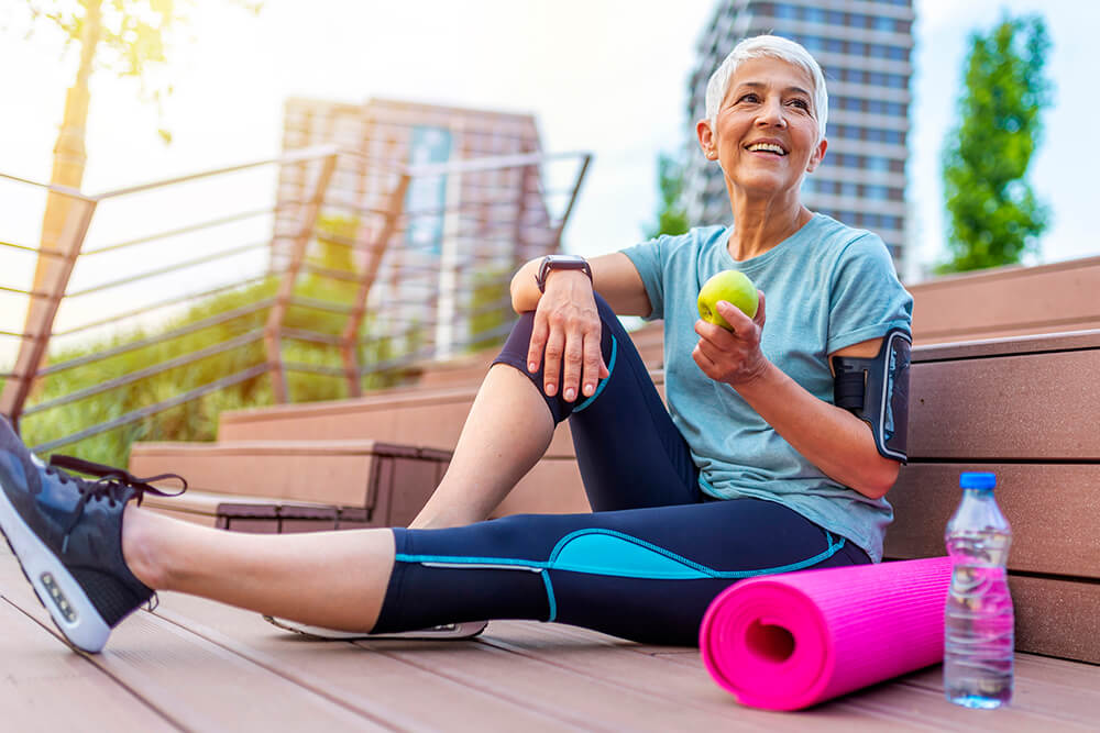 woman eating apple after run