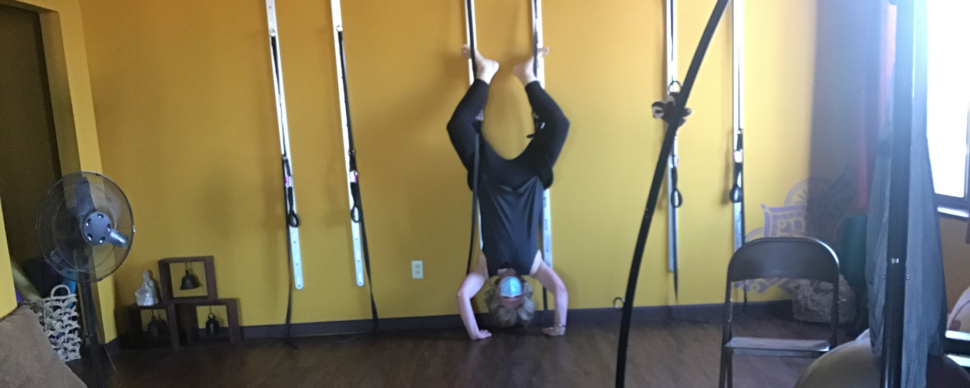 woman upside down in straps