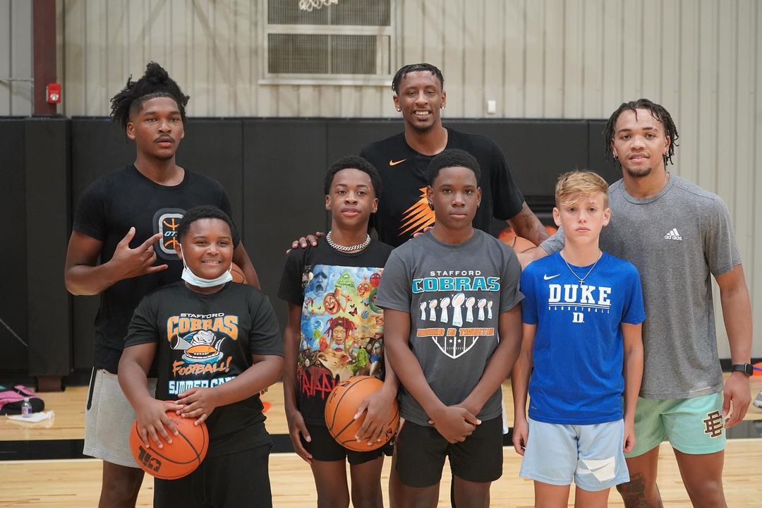 youth basketball players with instructors