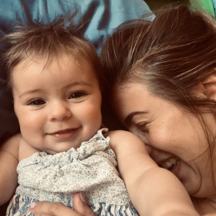 Woman holding baby at Yoga Bumps & Babies