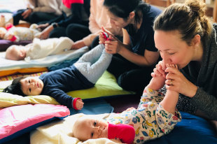 Mums playing with babies feet at Yoga Bumps & Babies